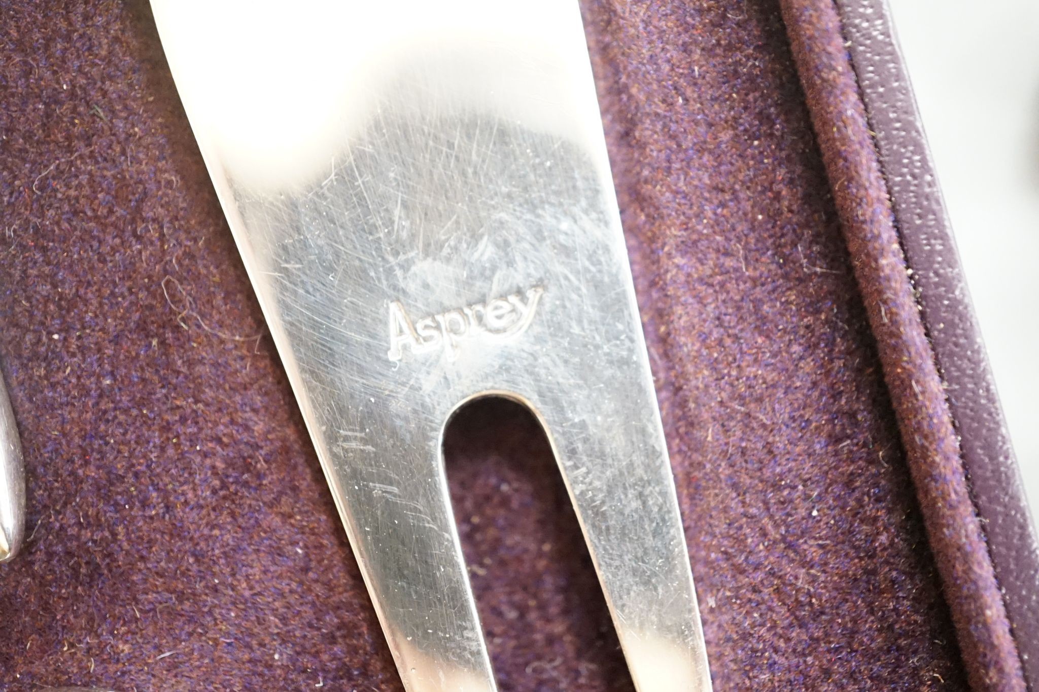 A modern Asprey cased silver golfer's companion set, comprising a tee, marker and pitch mark repairer, together with a set of six metal duck menu holders.
